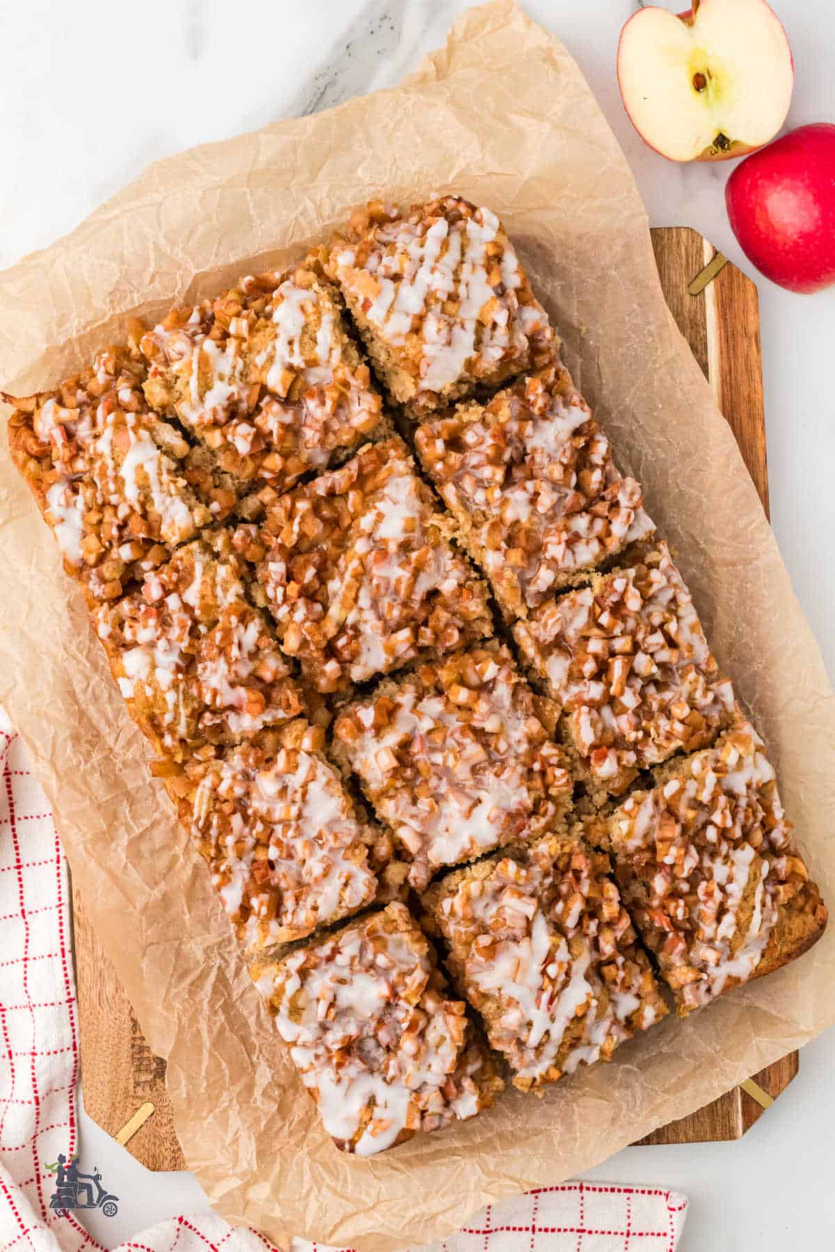 Apple fritter cake on a cutting board cut into squares and ready to eat.