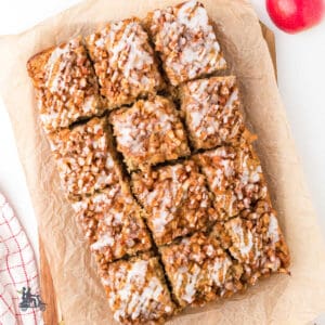 Apple fritter cake baked on parchment-lined baking dish for easy pan removal.