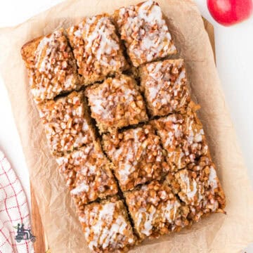 Apple fritter cake baked on parchment-lined baking dish for easy pan removal.