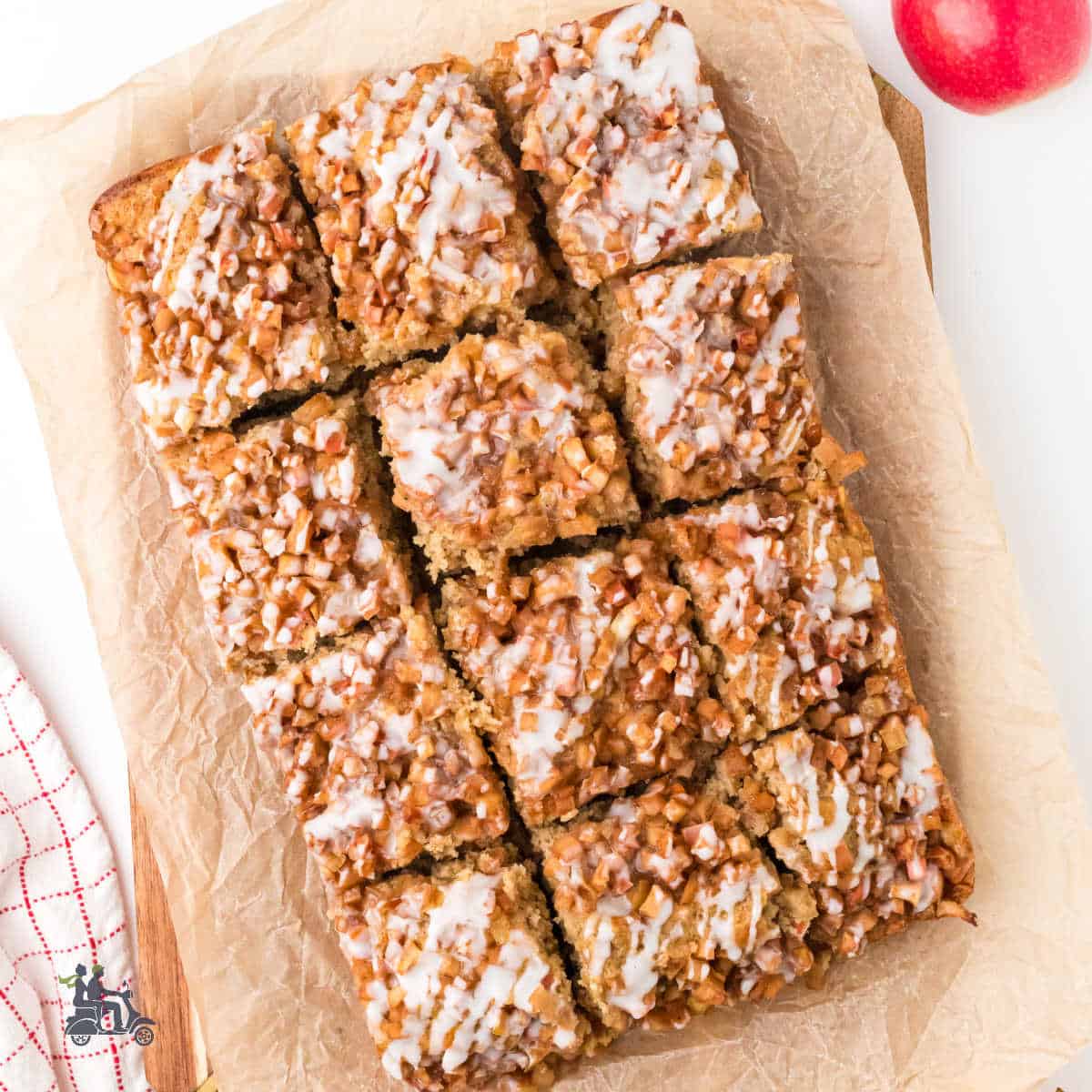Apple fritter cake baked on parchment-lined baking dish for easy pan removal.