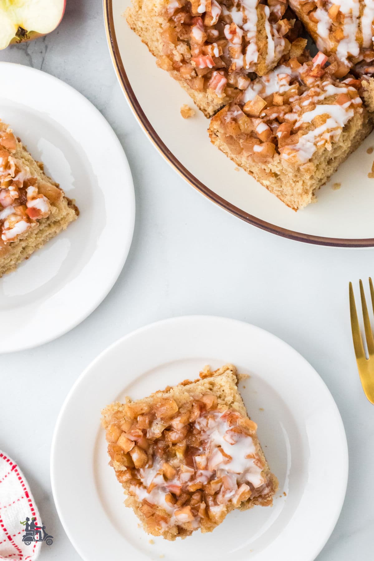 Overhead view of the cake mix apple fritter cake served on white dessert plates.
