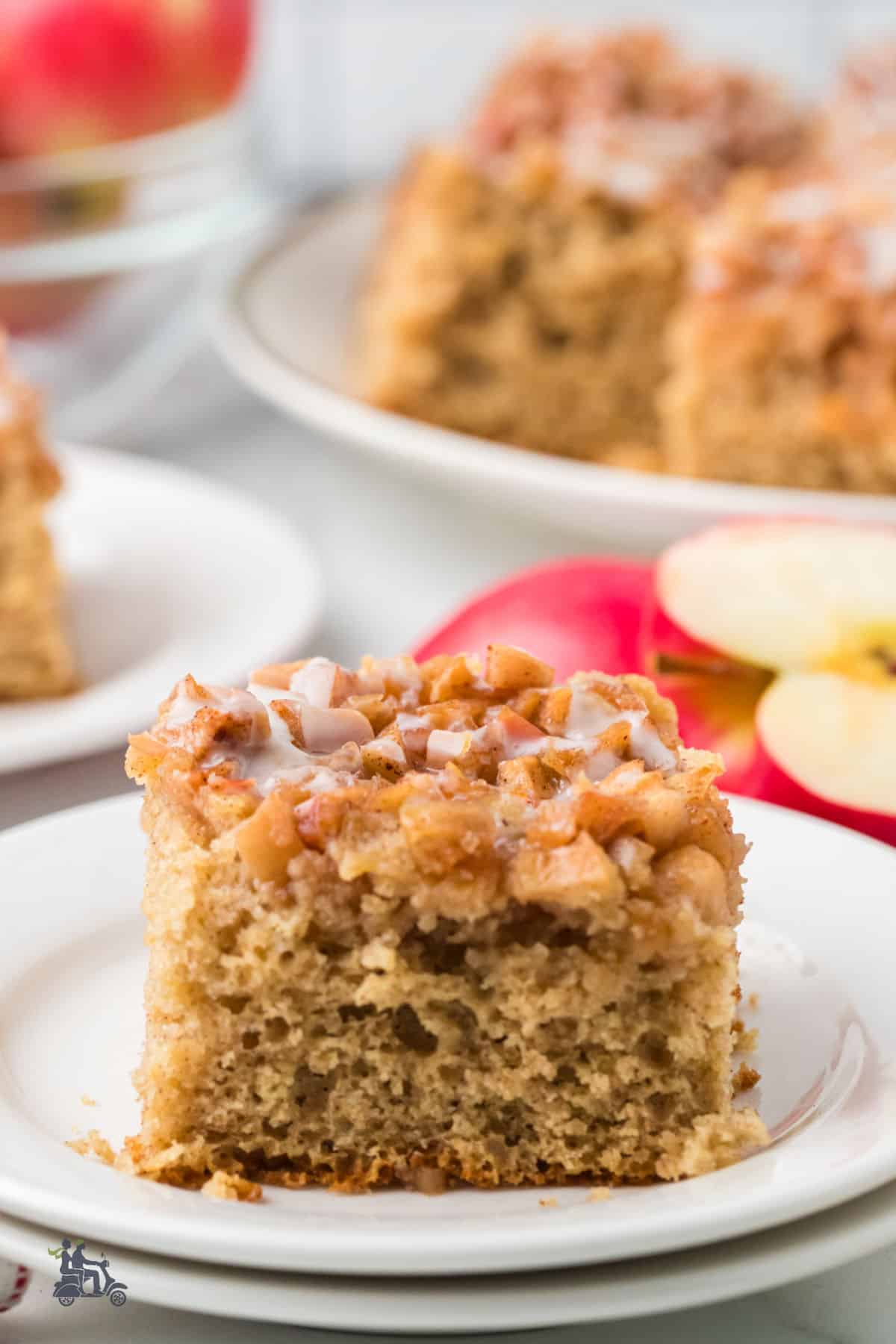 A side view of a square serving of apple fritter cake made using a boxed cake mix.