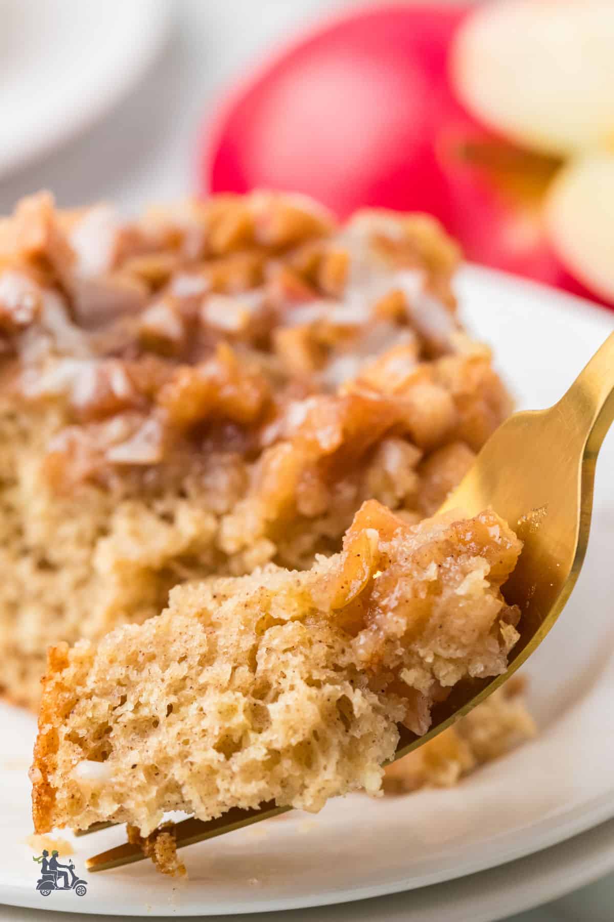 A fork slices into the easy apple fritter cake recipe made with a yellow cake mix.