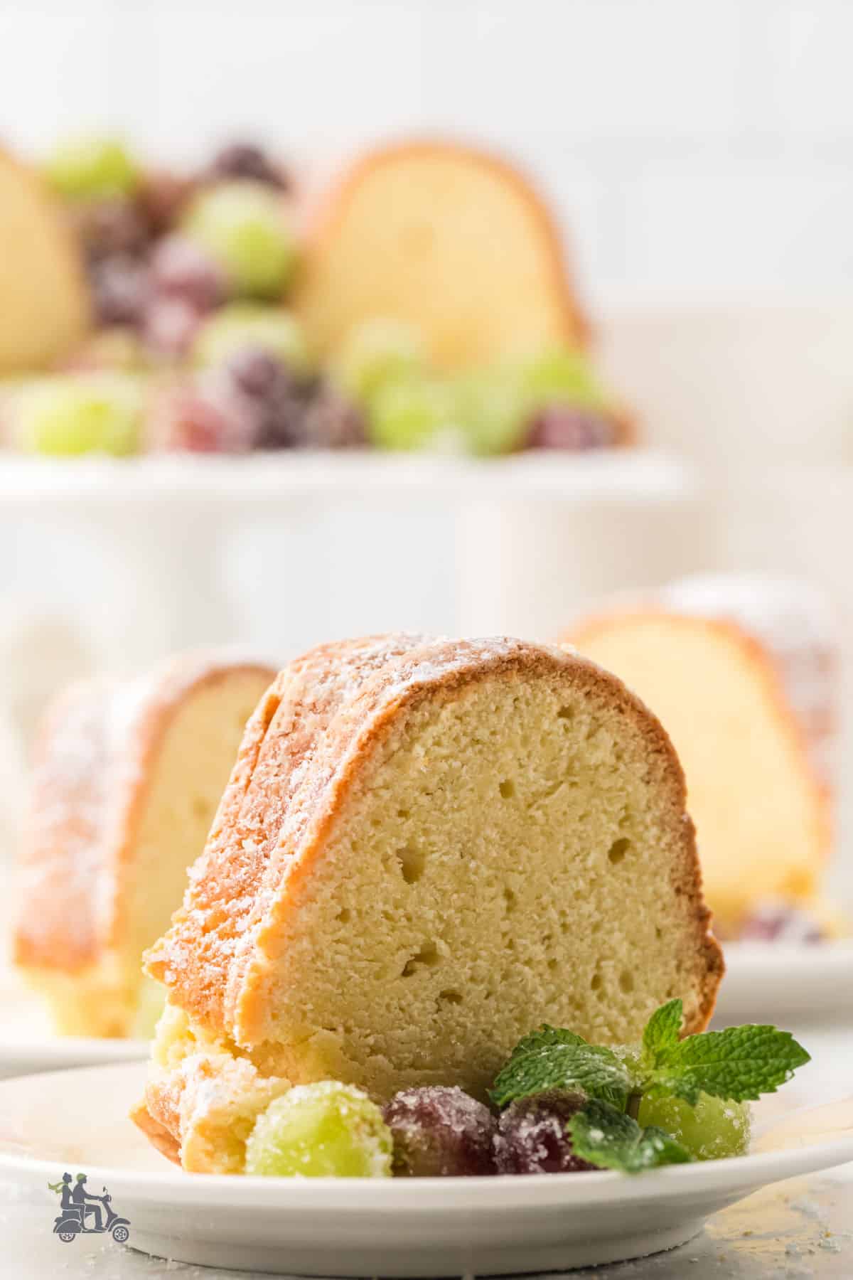 Irish Cake without frosting, with Sugared Prosecco grapes, served on a white plate.