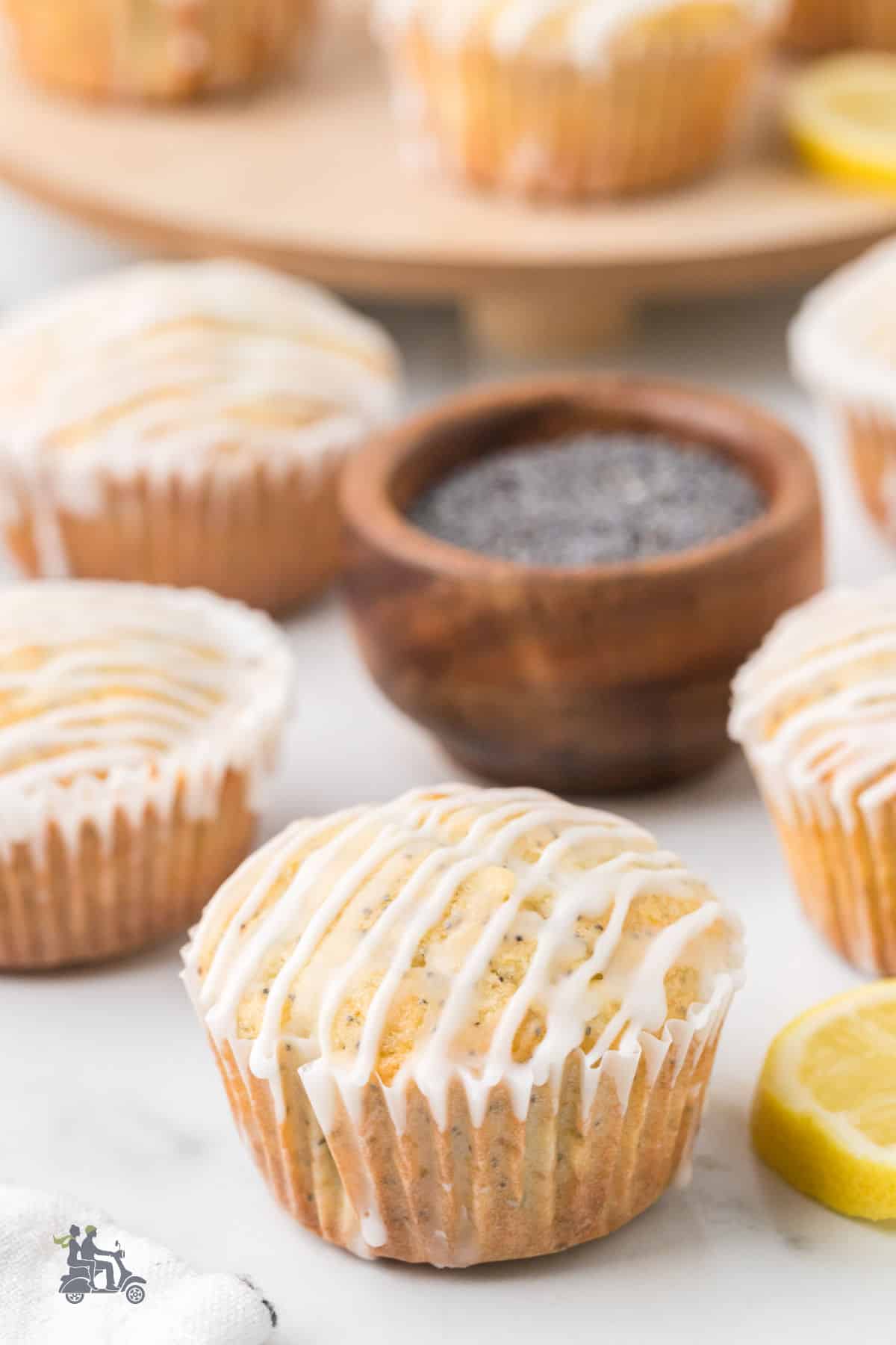 Soft lemon muffins studded with poppy seeds and drizzled with a lemon glaze. 