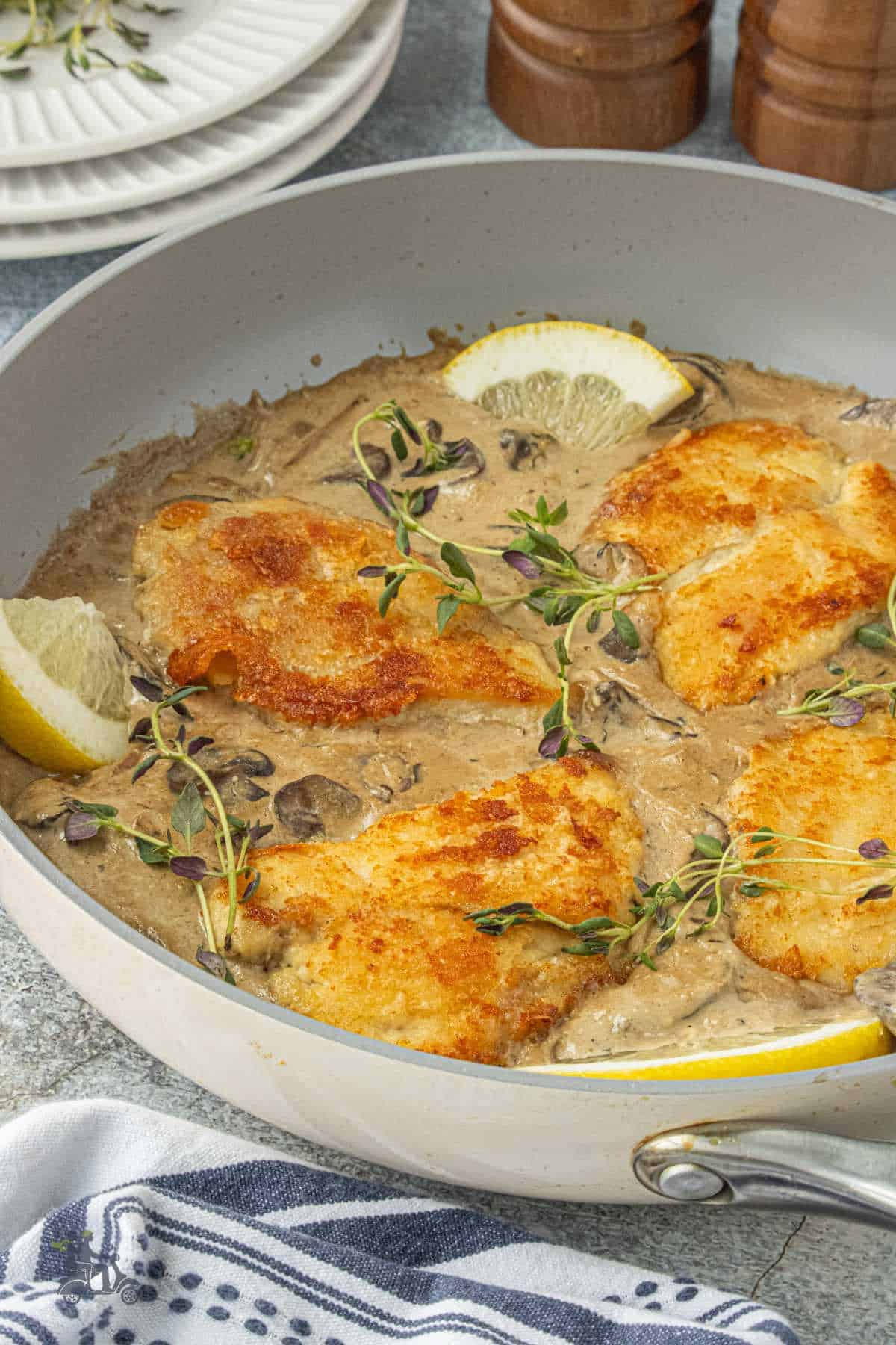 Creamy chicken in a creamy balsamic sauce with fresh thyme garnish.