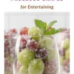 A Pinterest pin for sugared prosecco grapes in a glass goblet and decorated with a mint sprig.