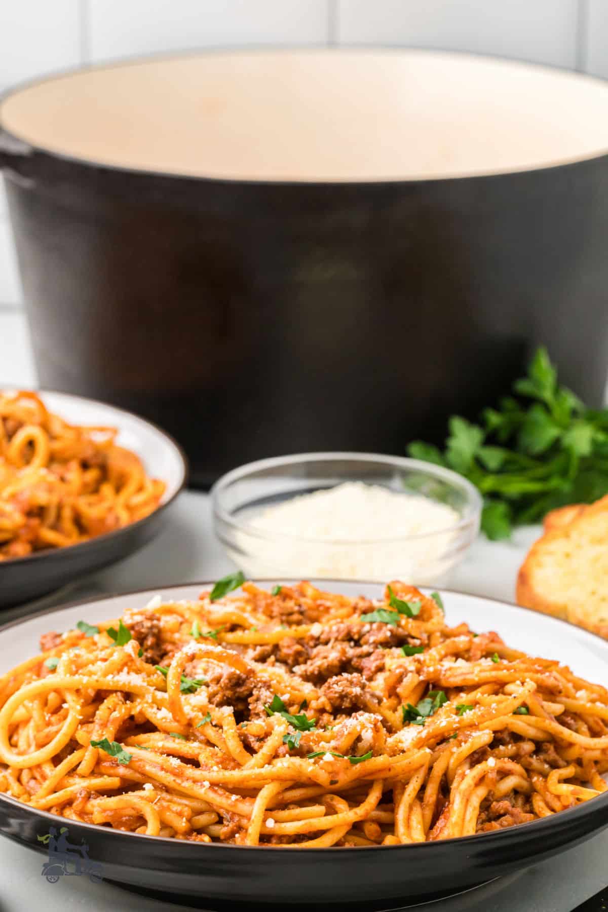 Pasta is cooked in one pot with ground beef and a spicy tomato base, then served in pasta bowls.