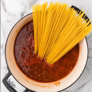 Dutch oven with the makings of the one-pan beef spaghetti recipe.