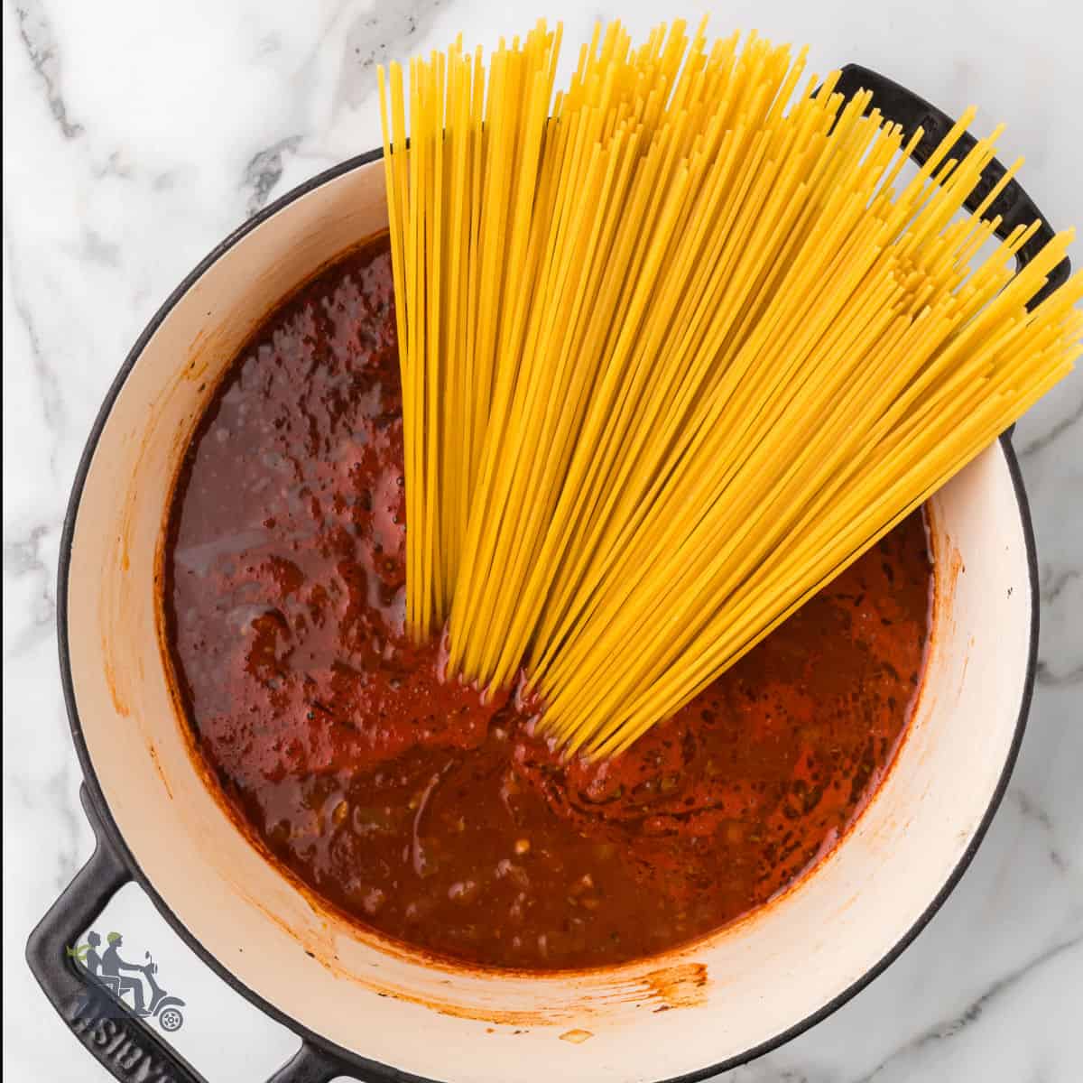 Dutch oven with the makings of the one-pan beef spaghetti recipe.