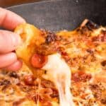 Easy Baked cheesy loaded pepperoni and sausage cheese dip that tastes like a pizza in a cast iron skillet.