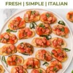 Tomato Basil Bruschetta on a round serving plate with shredded basil on top.