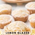 Homemade lemon poppy seed muffins with the muffin wrapper partially peeled off.