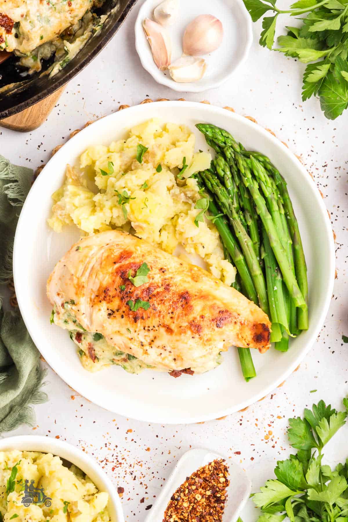Overhead view of the creamy spinach stuffed chicken breasts served on a dinner plate.