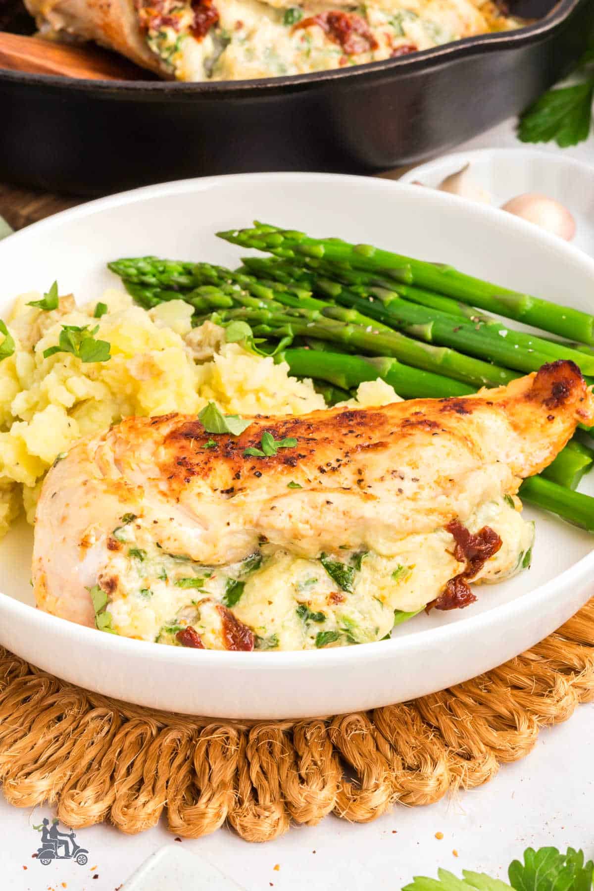 Italian-inspired stuffed chicken breast ready to serve with sides.