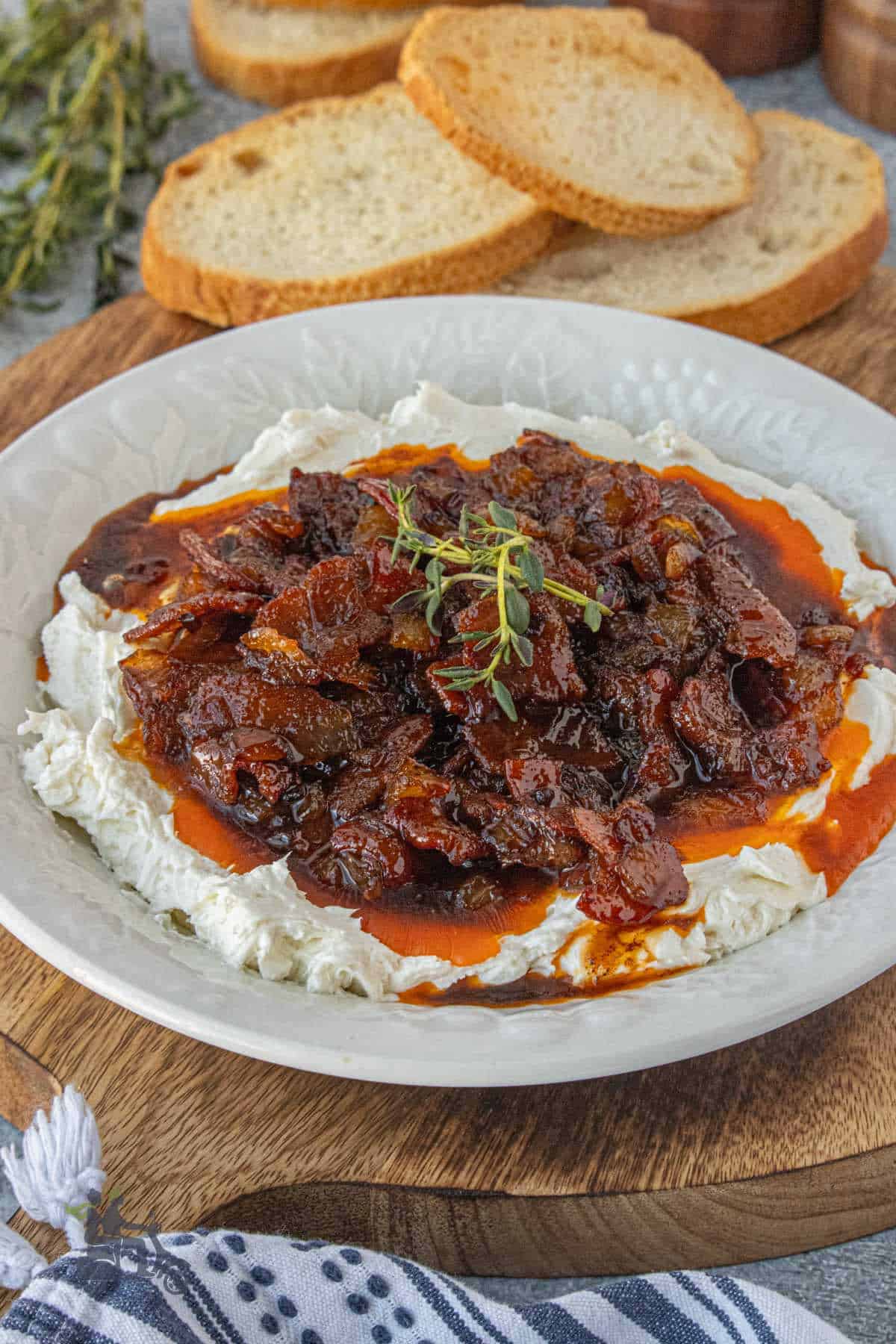 Whipped goat cheese topped with smoky bacon jam and fresh thyme leaves.