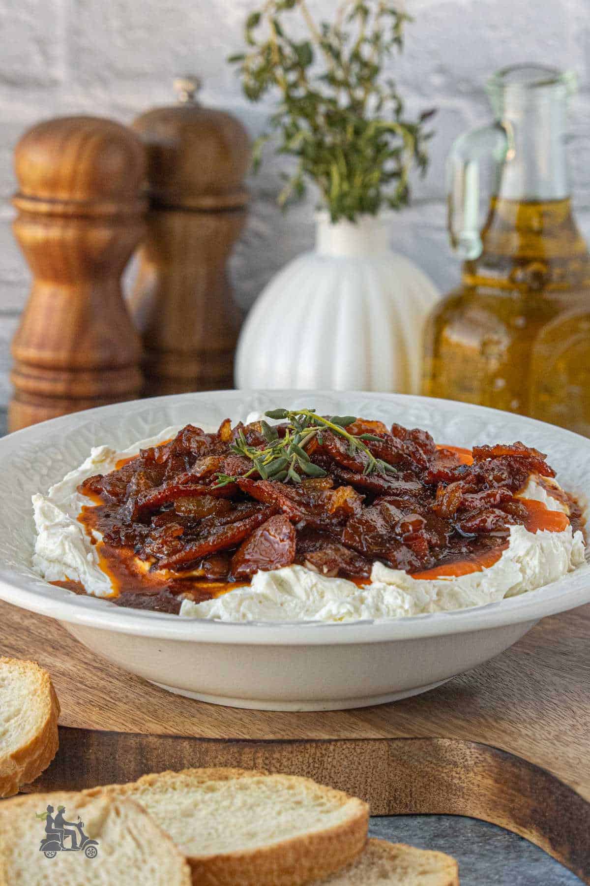 Elegant appetizer featuring whipped goat cheese and bacon jam served with homemade crostini.