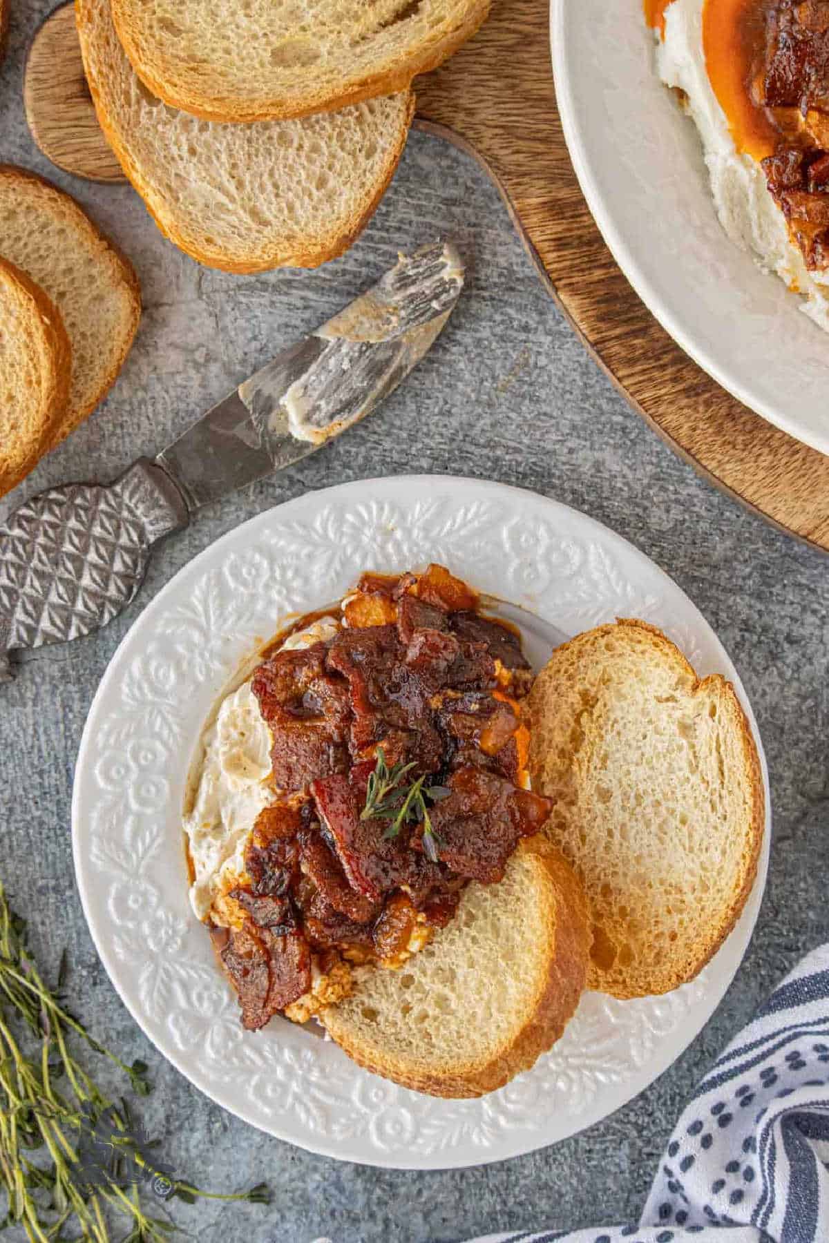 Sweet and savory bacon jam over whipped goat cheese served with garlic crostini.