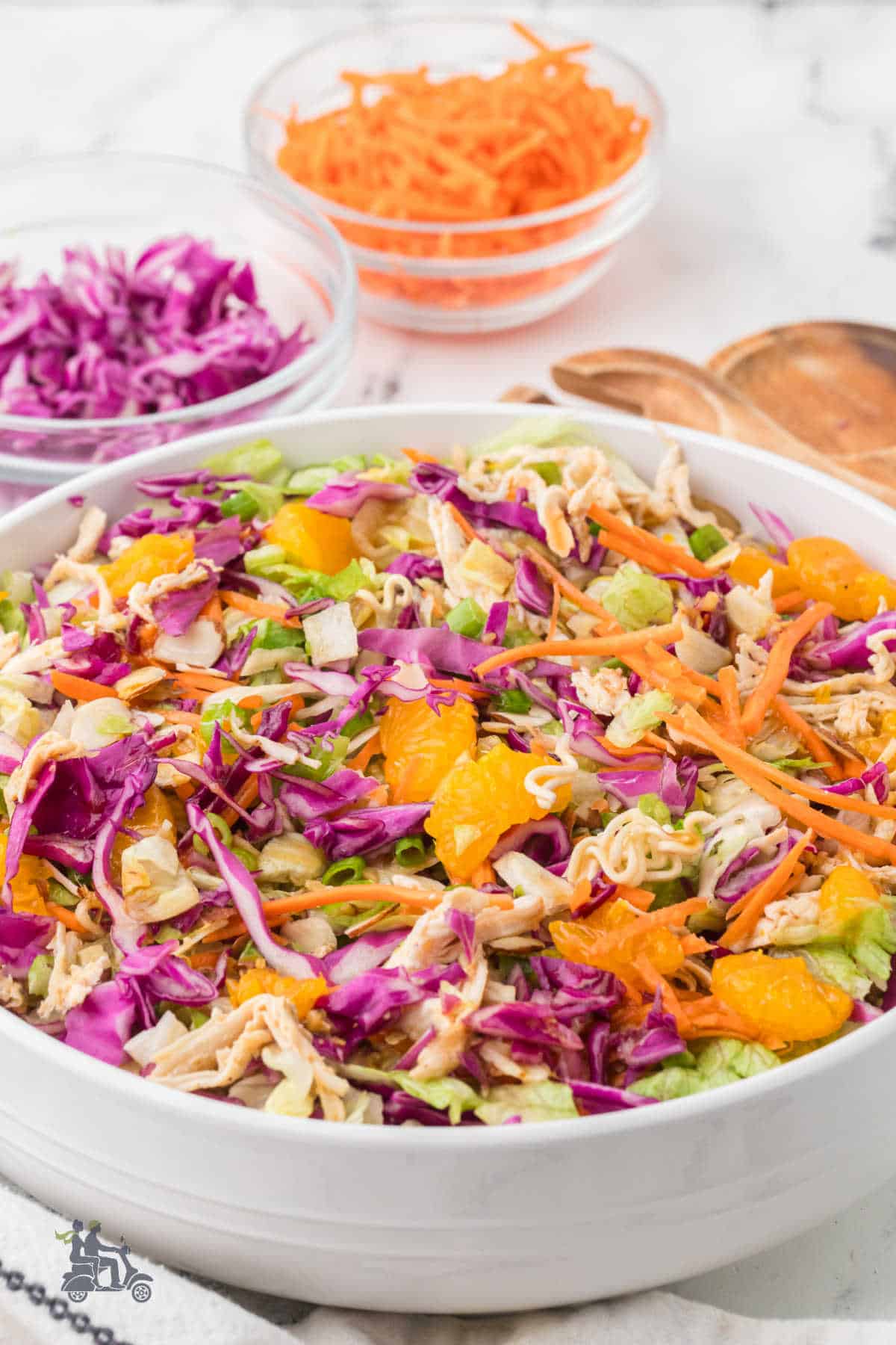 Fresh summer salad featuring chicken, lettuce, cabbage, almonds, and Asian sesame dressing.