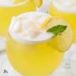 Close-up of a creamy limoncello sorbet float with melting lemon sorbet and sparkling bubbles.