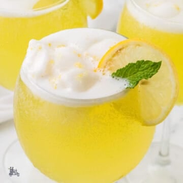 Close-up of a creamy limoncello sorbet float with melting lemon sorbet and sparkling bubbles.