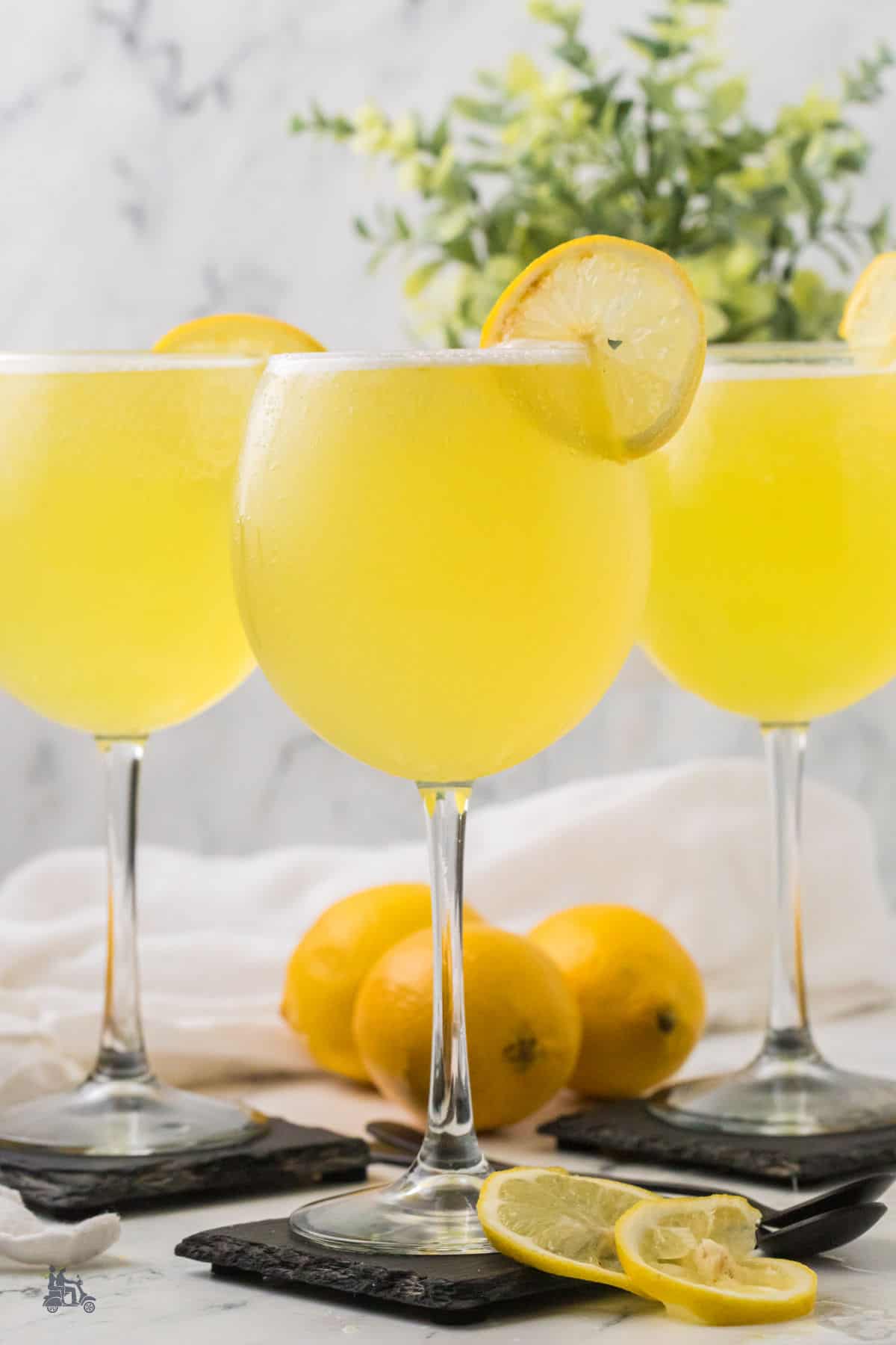 Refreshing limoncello cocktails topped with lemon sorbet and sparkling wine in clear glasses. 