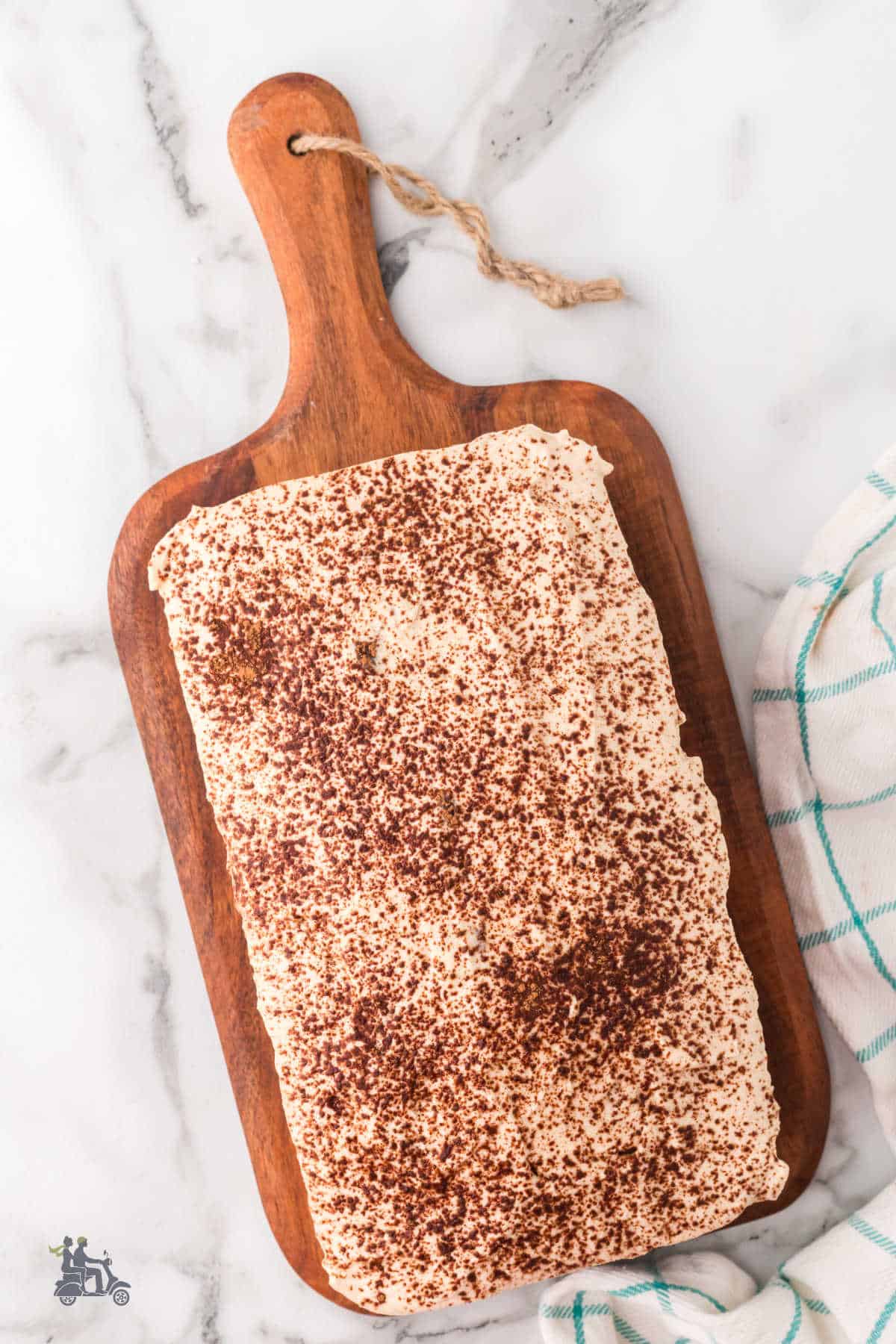 Coffee-flavored Dessert sweet bread on a wooden cutting board frosted and ready to serve.