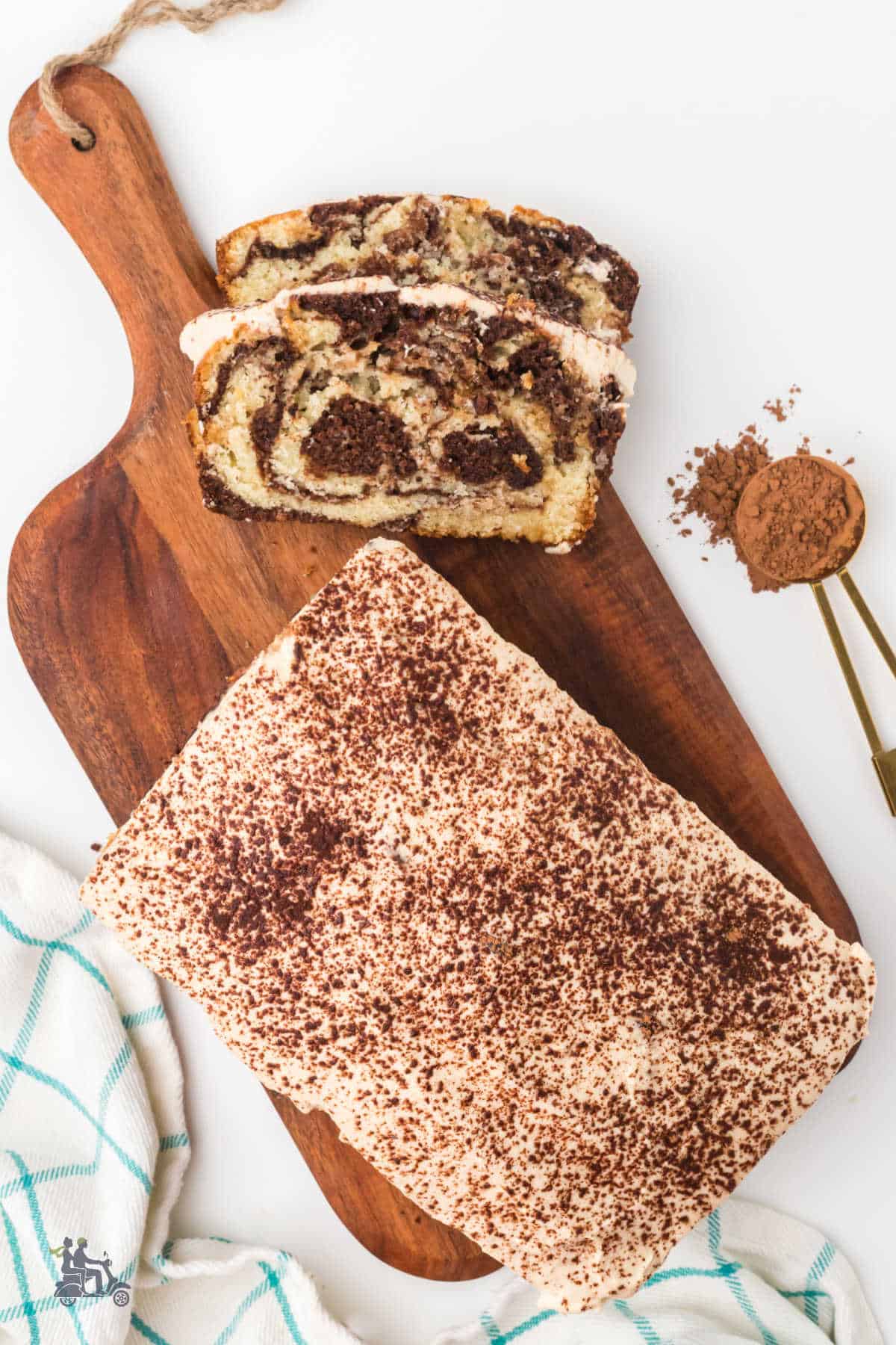 A Tiramisu sweet bread loaf on a cutting board, sliced and ready to enjoy.