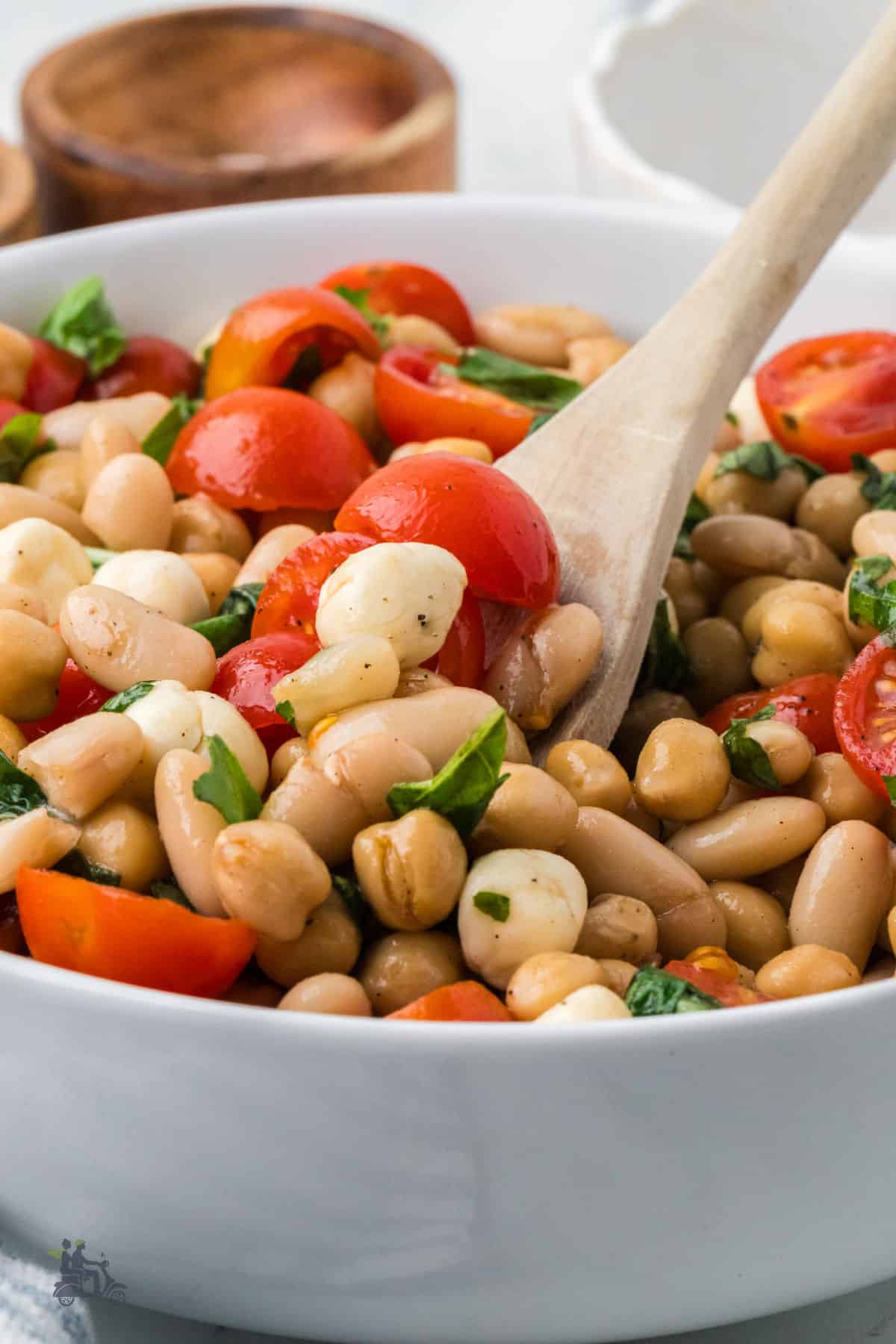 Halved cherry tomatoes and mozzrella pearls added to chickpeas and cannellini beans and tossed with a balsamic vinaigrette dressing.