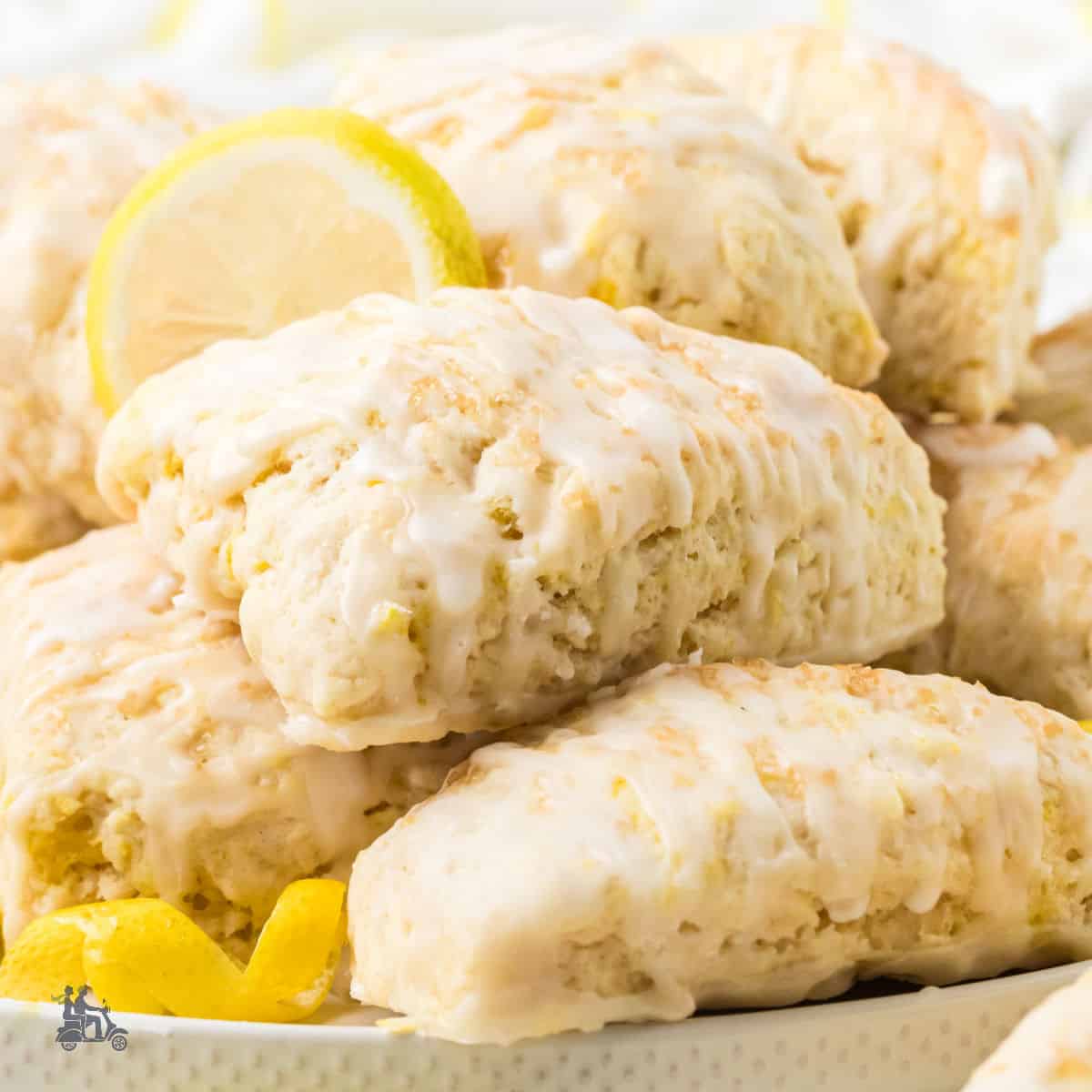 A close-up of lemon scones glazed with a lemony powdered sugar glaze.