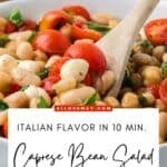 A spoonful of Caprese dense bean salad with tomatoes, mozzarella, basil, and white beans.