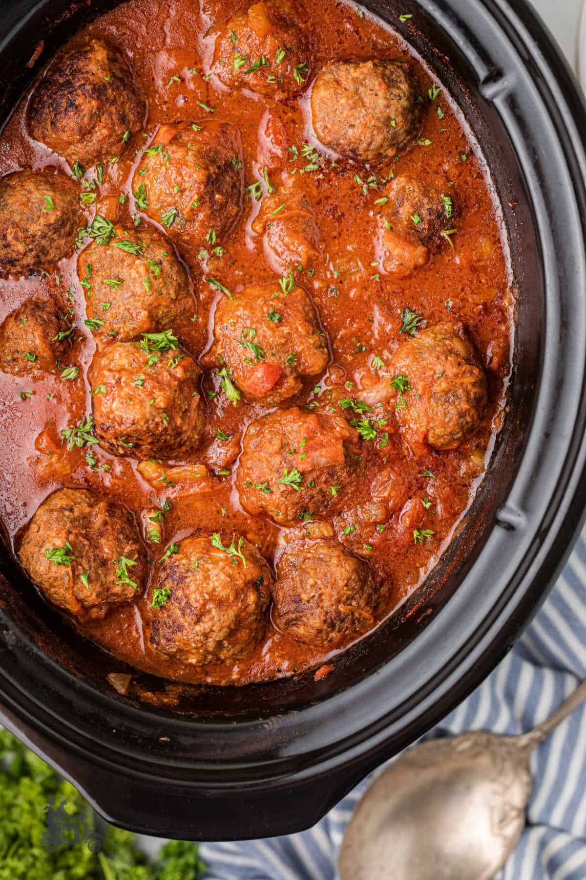 Slow cooker filled with homemade Italian meatballs and savory tomato sauce.