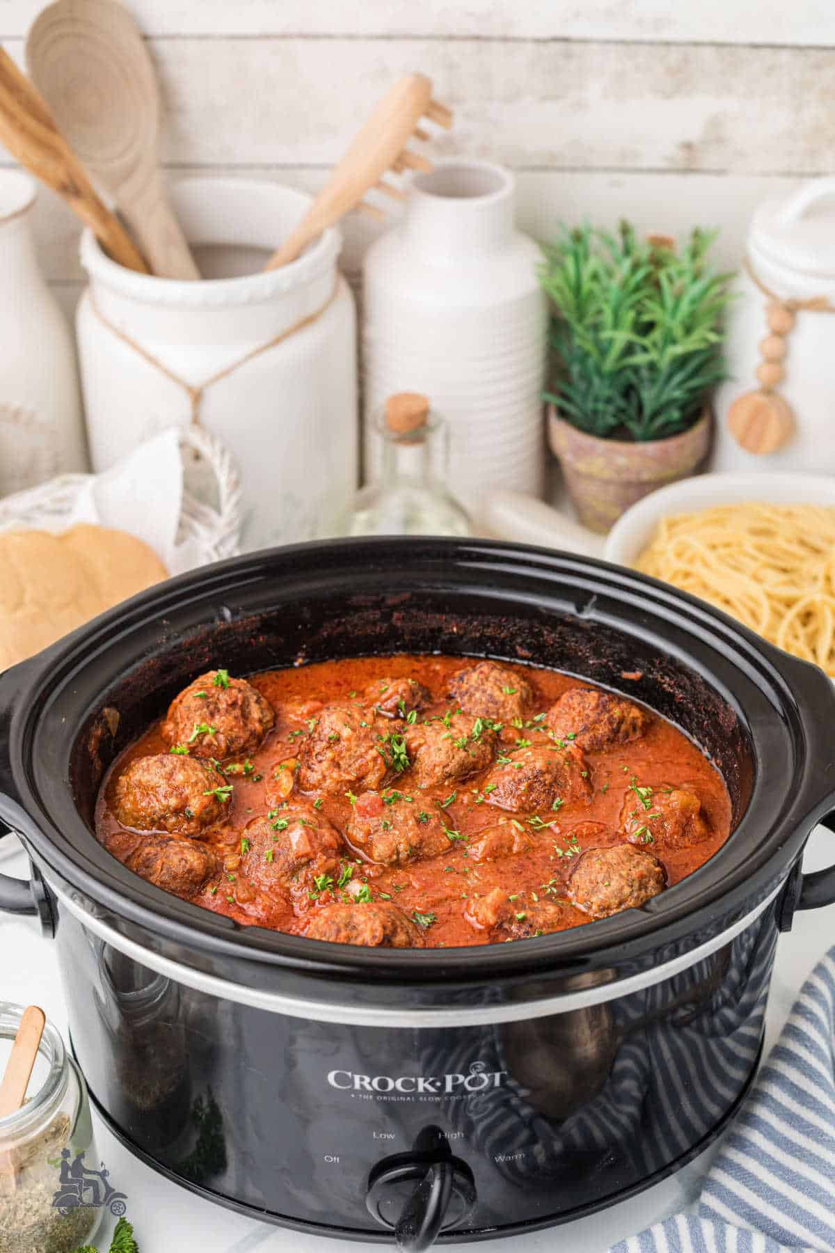 Slow cooker filled with homemade Italian meatballs in a savory tomato sauce. 