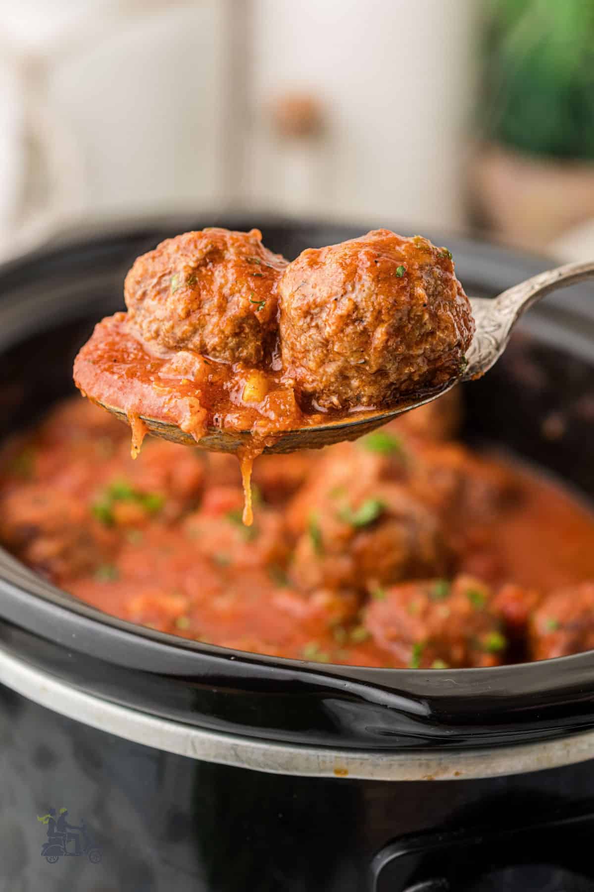 Close-up of tender beef and Italian sausage meatballs covered in rich tomato sauce.