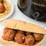 A hoagie bun filled with homemade meatballs covered in tomato sauce.