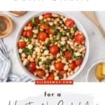 The ultimate bean salad made in an Italian style with halved cherry tomatoes, mozzarella pearls, and two-different types of beans.