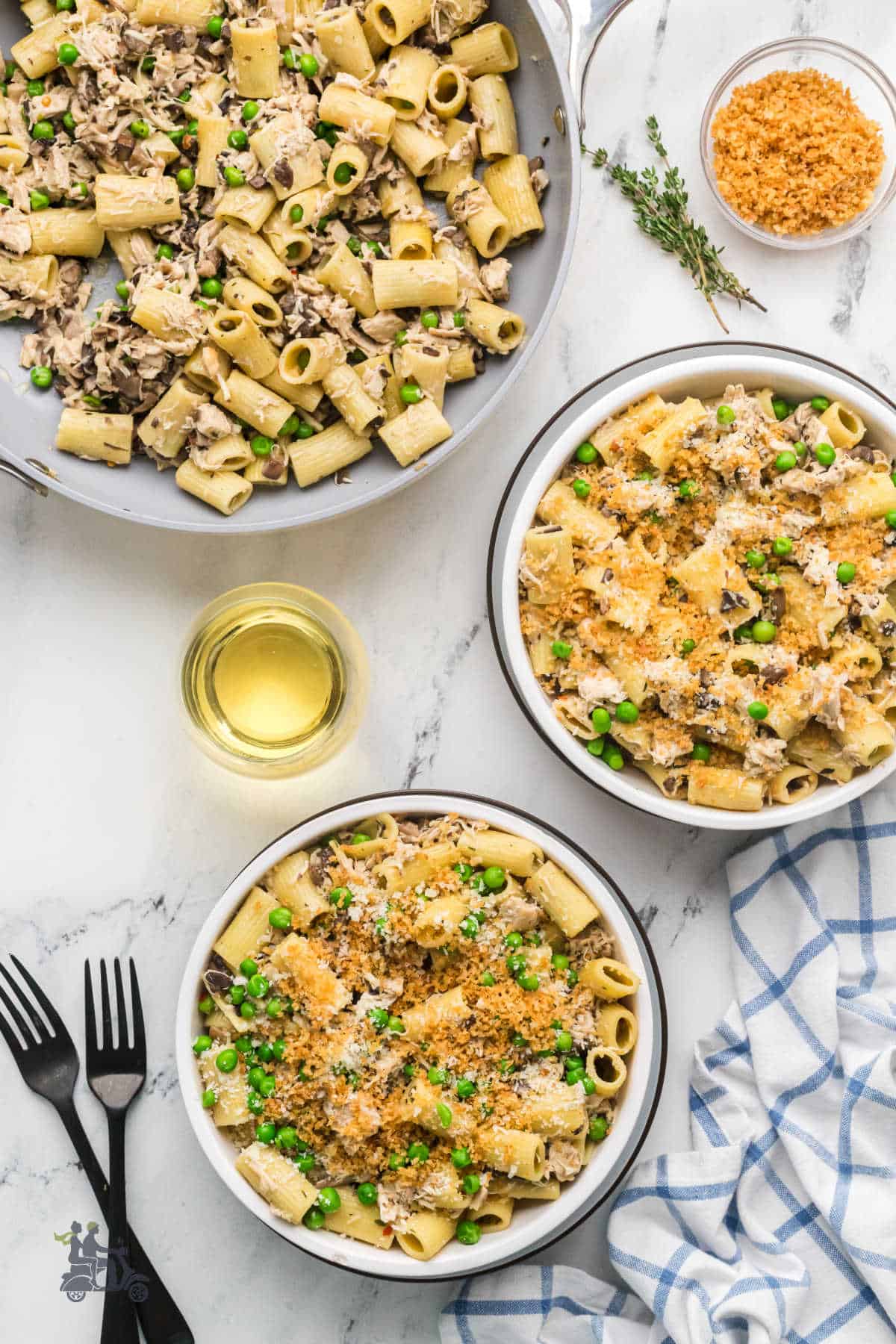 Stovetop chicken tetrazzini made with rotisserie chicken and served in white bowls with panko breadcrumb and Parmesan cheese topping. 