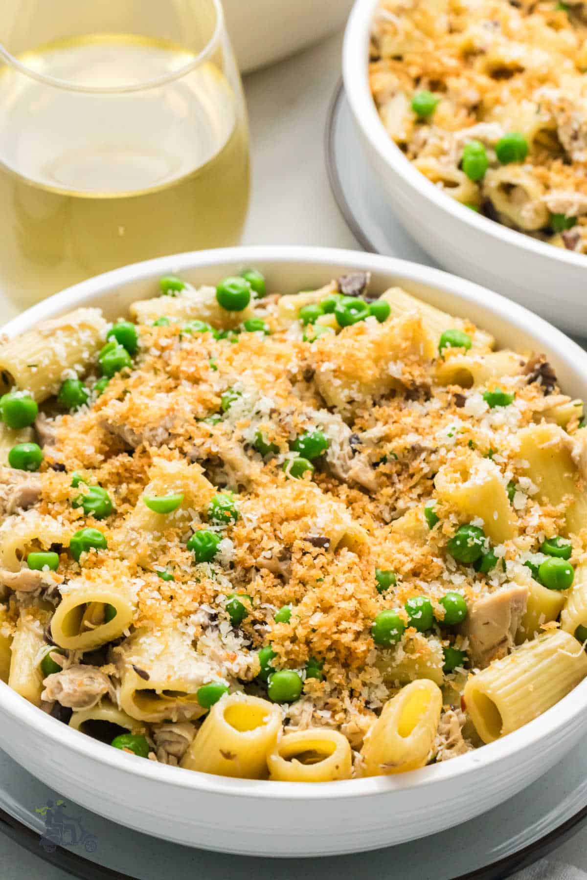 Side view of stovetop chicken tetrazzini served in a white bowl with golden panko breadcrumbs on top.
