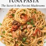 Spaghetti alla Carrettiera on a white plate served with a sprinkle of chopped parsley.