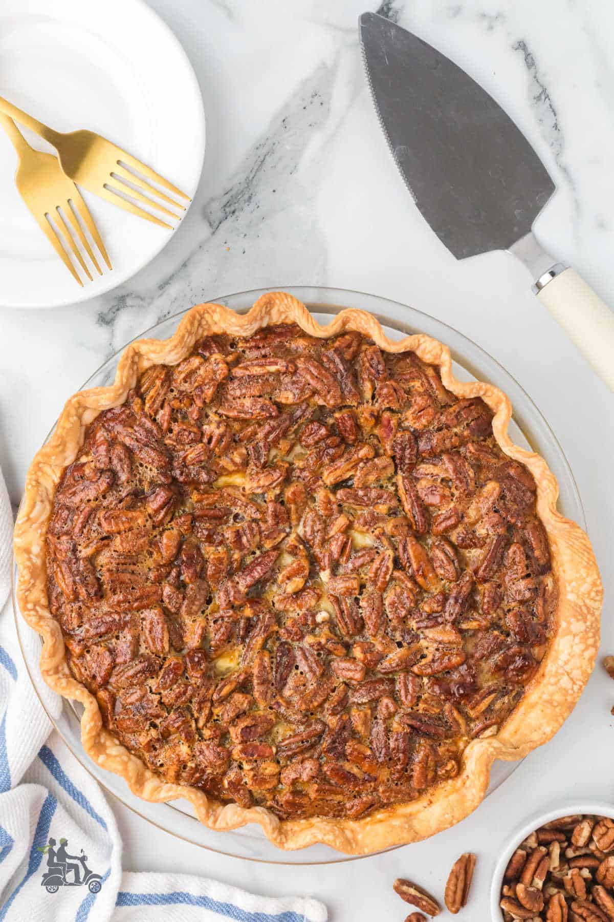 A golden pecan top creamy cheese layered pie. An easy store-bought crust makes the pie a breeze to make.