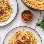 Two bowls of budget-friendly tuna pasta with the pasta pot on the side.