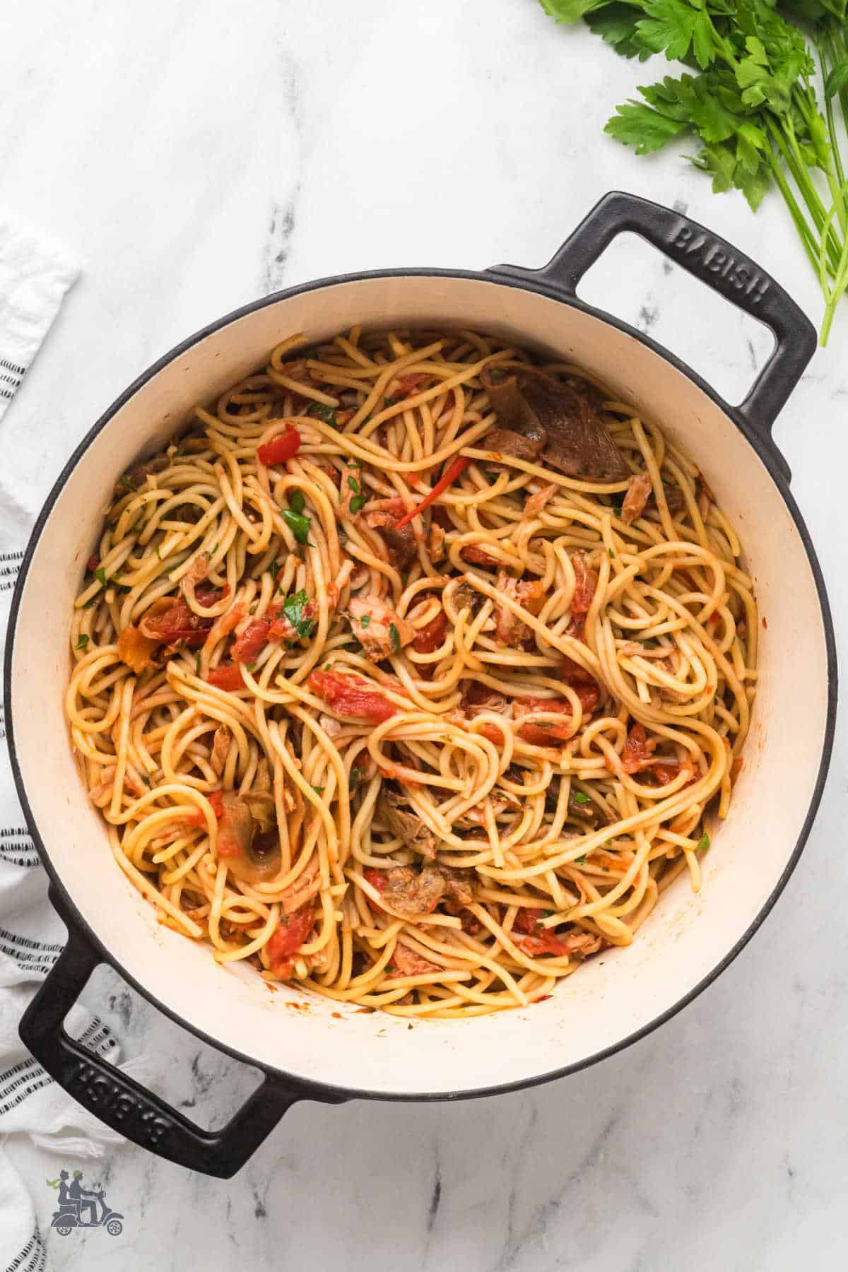 Dutch oven with tuna spaghetti mixed with a homemade tomato-mushroom sauce.