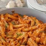 Penne pasta with vodka sauce made with San Marzano tomatoes in a deep braiser.