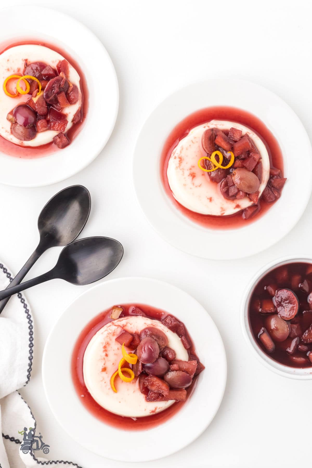 Overhead view of creamy buttermilk panna cotta with orange-and-cinnamon-scented fruit.