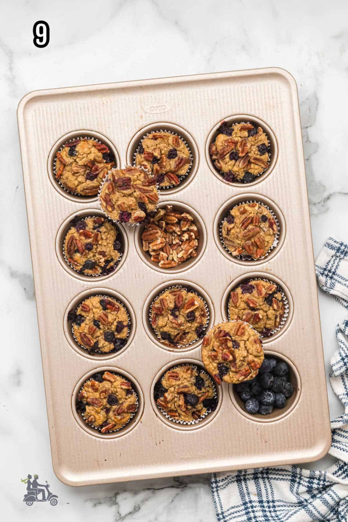 The finished Maple syrup sweetened blueberry muffins in a tin muffin pan.