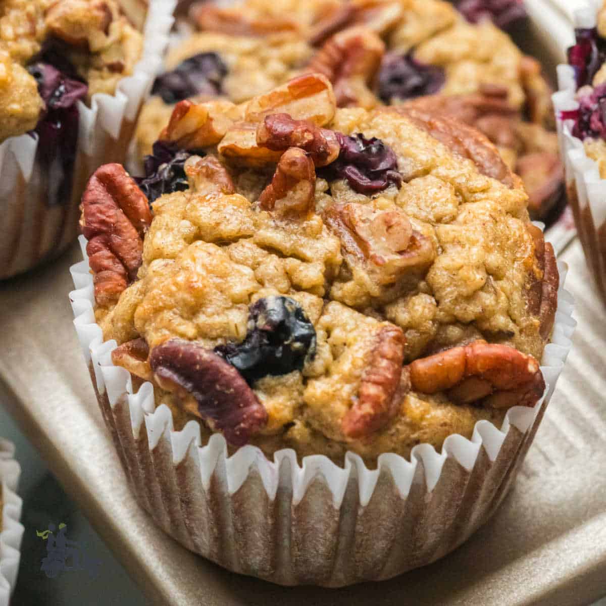 Banana oatmeal muffin with pecans for a healthy, flourless baked muffin.