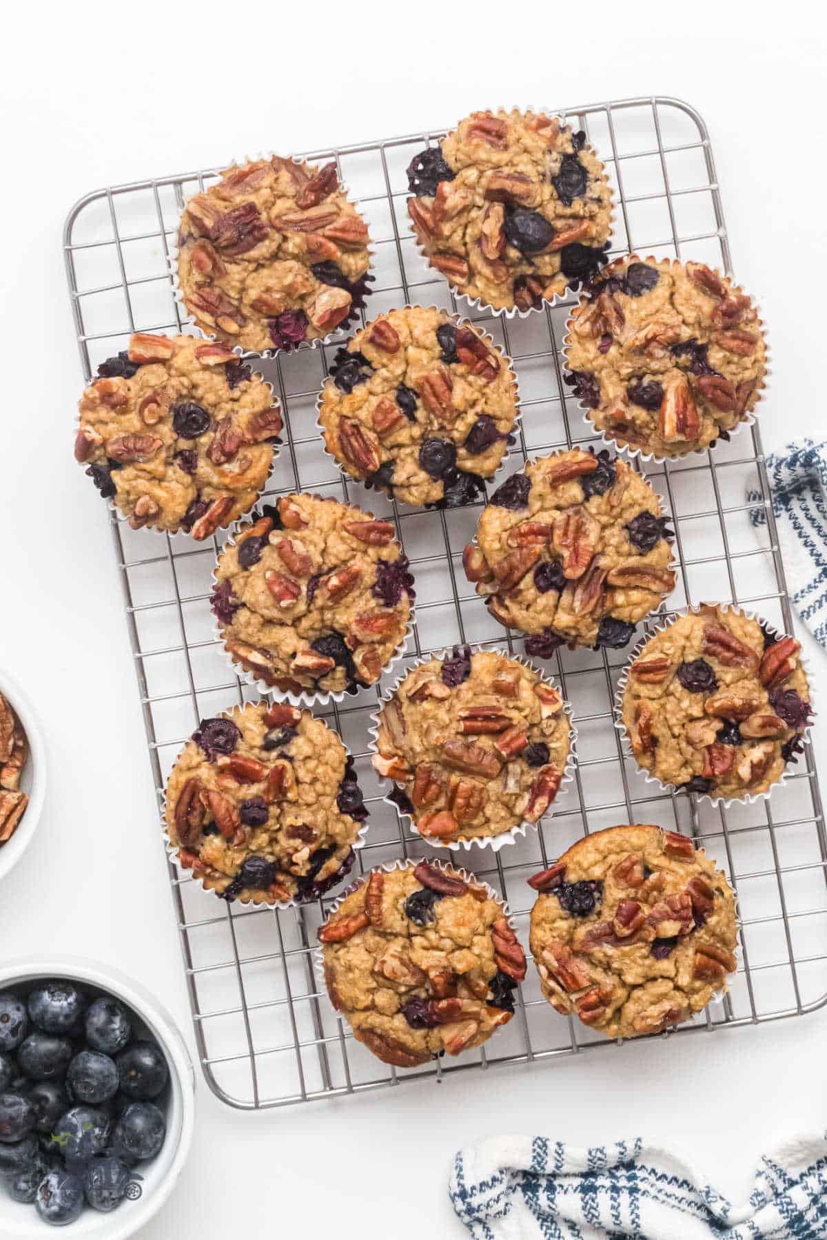 Yogurt Oatmeal Blueberry Banana muffins cooling on a iron rack.