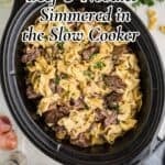 Slow cooker cooks chuck roast pieces in a gravy with egg noodles for a hearty family dinner.