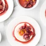 Fall Panna Cotta with Ruby Port Fruit Compote served on white plates.