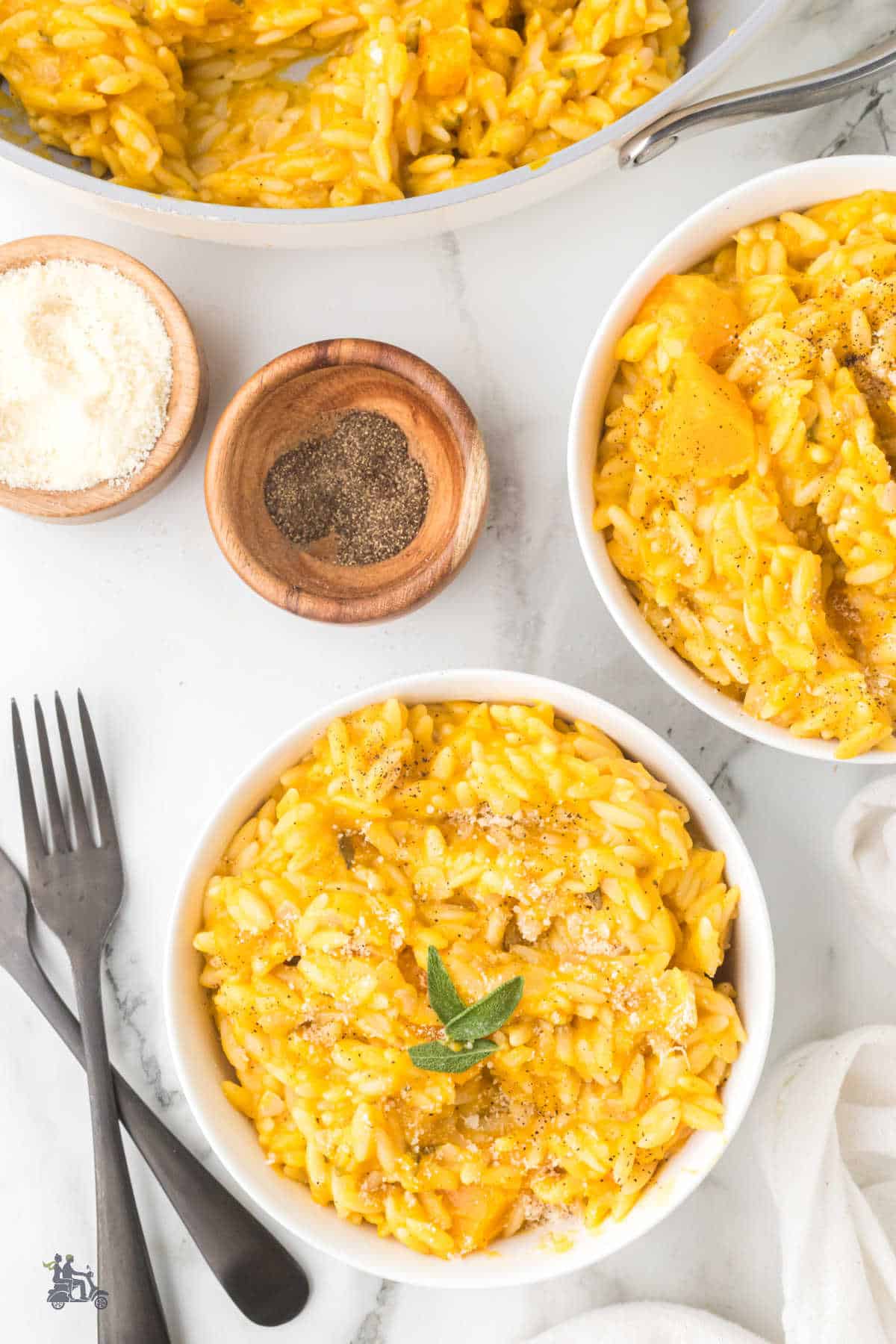 Orzo pasta is mixed with butternut squash to make a creamy risotto seasoned with sage leaves and Parmesan cheese. 